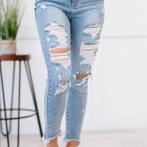 high rise distressed blue jeans